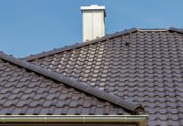 Gte klinkerbungalow met klinkergevel en W6v in edelnero op het dak met focus op de graad met cilindrische nokpan en de afbeelding van de afdekkingro