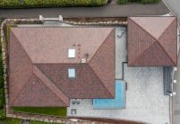 Zicht in vogelvlucht op schilddak met stylist in cottage.